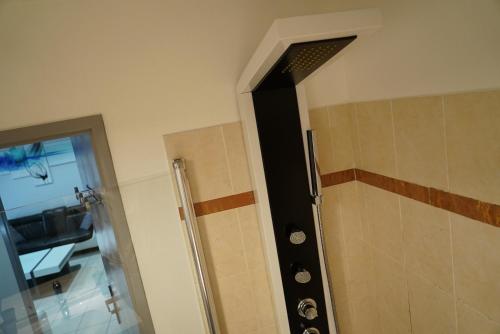 a bathroom with a shower with a black door at Appart&Spa in Toulouse
