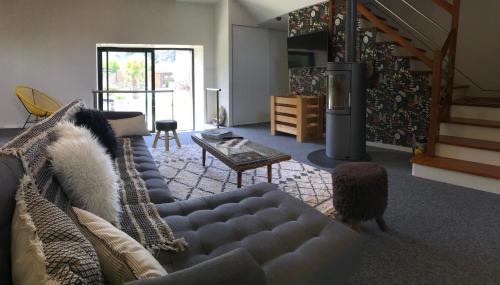 a living room with a couch and a table at Chambres D'Hotes L'Atipic in Saint-Brieuc