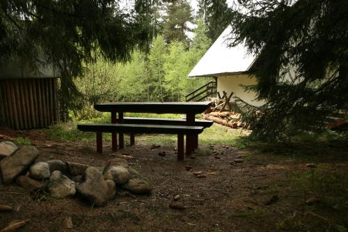 a picnic bench sitting in the middle of a yard at Chata Čučka in Pribylina