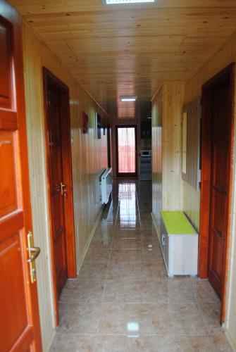 an empty hallway of a kitchen with wooden walls at Rózsapark Vendégház in Demjén