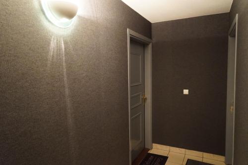 a room with a light on the wall and a door at Appart&Spa in Toulouse