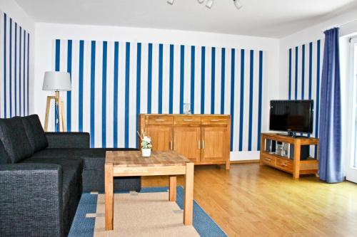 a living room with a couch and a tv at Hof Kranichstein in Kluis