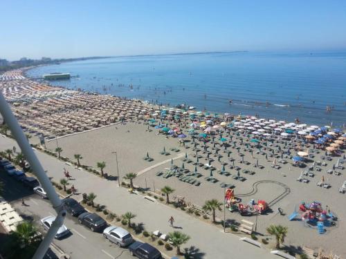 a beach with a lot of umbrellas and people at Apartment Sea View in Shëngjin