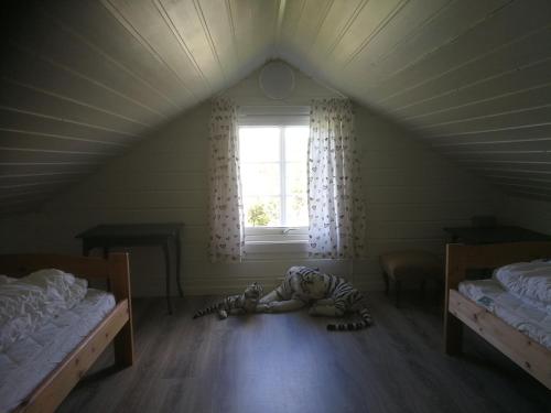 a room with two beds and a zebra laying on the floor at Hagen in Vennesla