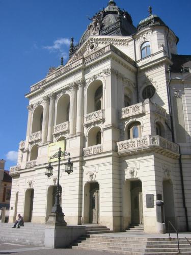a large white building with stairs in front of it at Hotel Gloria Palac in Košice