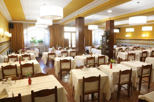 a dining room with white tables and chairs at Fonda Rita in Sant Hilari Sacalm