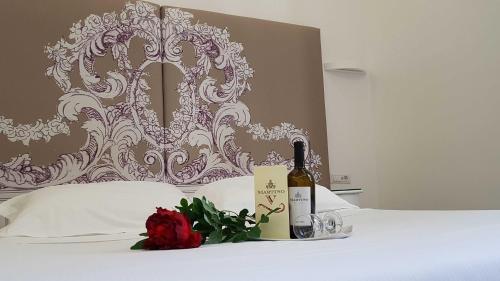 a white table topped with a bouquet of flowers at Easyrome Guest House in Rome