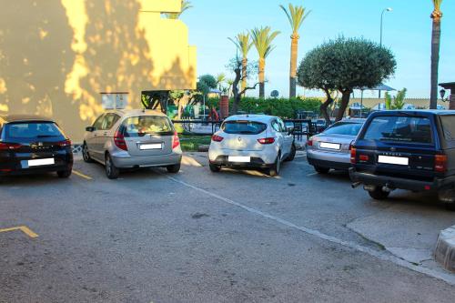 a bunch of cars parked in a parking lot at Hostal Esperanza in Benajarafe