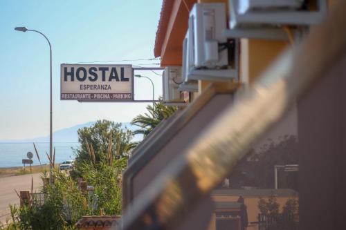a hotel sign in front of a building at Hostal Esperanza in Benajarafe