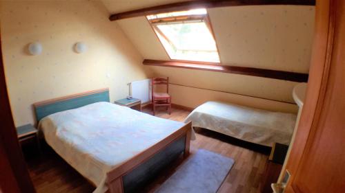 a small bedroom with a bed and a window at Chez Loly in Trébeurden