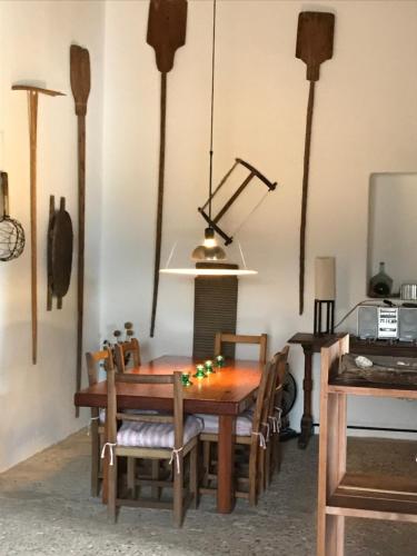 a dining room with a wooden table and chairs at Casa Andrea in Sant Francesc Xavier