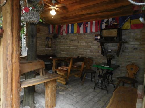 a room with a table and chairs and a stove at Villa Anna in Palić