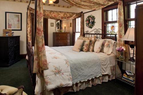 a bedroom with a bed with a canopy at Cliff Cottage Inn, Downtown Bed & Breakfast in Eureka Springs