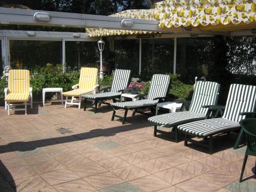a group of chairs sitting on a patio at Hotel Pension Loose in Borkum