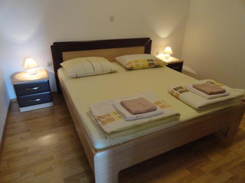 a bedroom with a bed with two lamps on it at Tona in Rovinjsko Selo