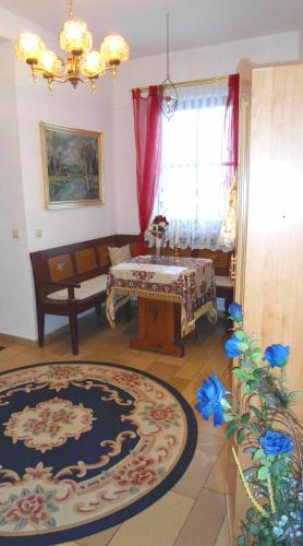 a living room with a table and a couch at Hotel Krone in Gößweinstein