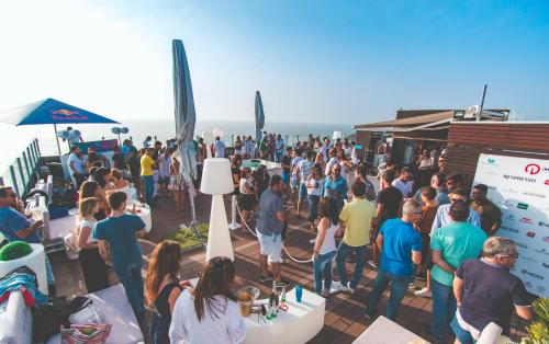 a crowd of people standing around at a party at Hotel Mar e Sol & Spa in São Pedro de Moel