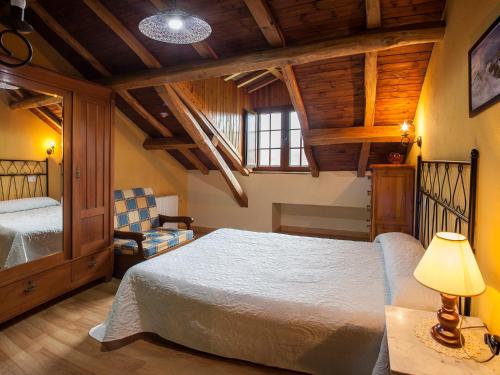 Casa de Aldea Carboneiro في Naraval: غرفة نوم بسرير ومصباح وكرسي