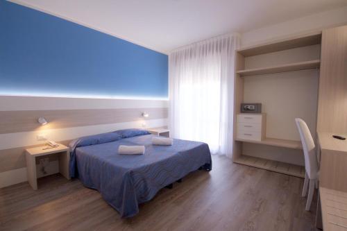 Postel nebo postele na pokoji v ubytování Hotel Serenella