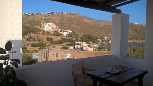 a room with a table and a view of a mountain at PATMOS Mathios Studios- apartments in Patmos