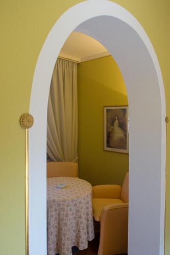 an archway leading into a room with a table and a couch at Hotel Locanda Mel in Calolziocorte