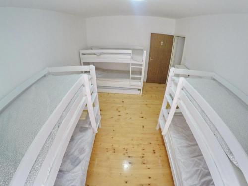 two bunk beds in a room with a wooden floor at Mostar Downtown Hostel in Mostar