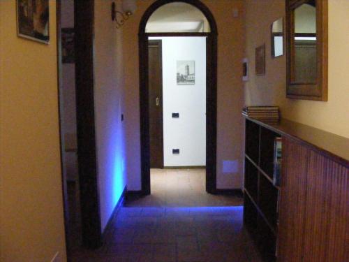a hallway with a white door and a blue light at B&B Orio BGY in Orio al Serio