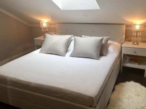 マリ・ロシニにあるApartments Tashaの白いシーツと枕が付いた大きなベッドのある寝室