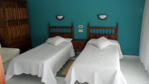 Кровать или кровати в номере Hostal La Paz