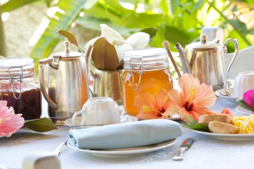 a table with food and honey and flowers on it at Boutique Hotel Su Sergenti in Villasimius