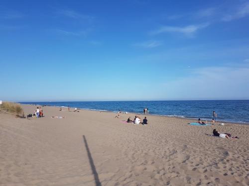 a group of people on a beach near the ocean at Gava Ocean View in Gavà