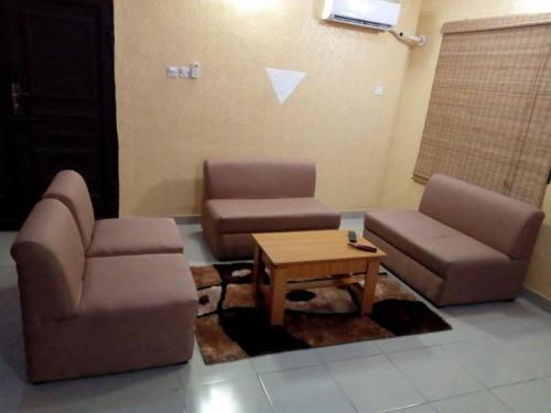 a living room with two chairs and a coffee table at Solar and Inverter Full Service 3 Bedroom Flats in Ikeja
