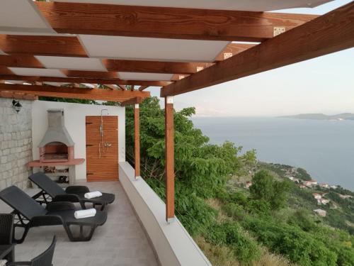 a balcony with a view of the ocean at Grandpa's dream in Lokva Rogoznica
