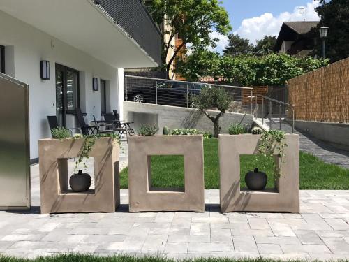 three containers with plants in them on a patio at Apartment Zielspitz in Parcines