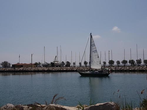 a small sail boat in a body of water at Port saint Louis du Rhône magnifique vue sur mer in Saint-Louis-du-Rhône
