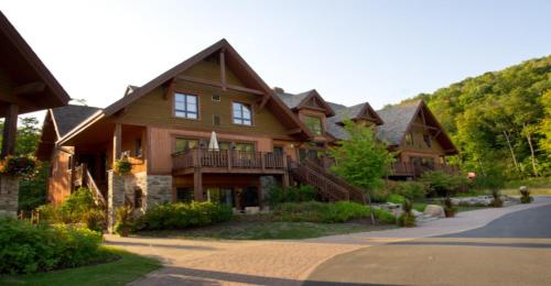 a large wooden house with a gambrel at Étoile du Matin by Rendez-Vous Mont-Tremblant in Mont-Tremblant
