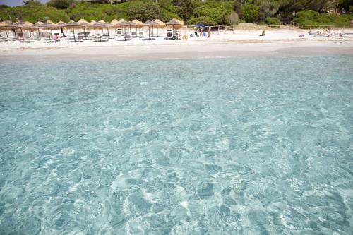 a view of the clear blue water of a beach at Boutique Hotel Su Sergenti in Villasimius