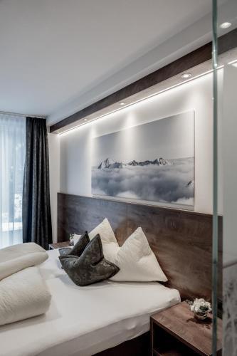a bedroom with two beds and a picture on the wall at The View by Regina in Sölden
