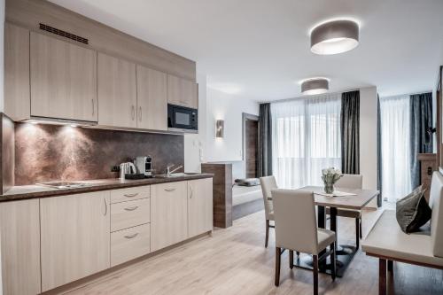 a kitchen and dining room with a table and chairs at Regina's Alpenpanorama in Sölden