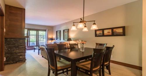 a dining room and living room with a table and chairs at Étoile du Matin by Rendez-Vous Mont-Tremblant in Mont-Tremblant