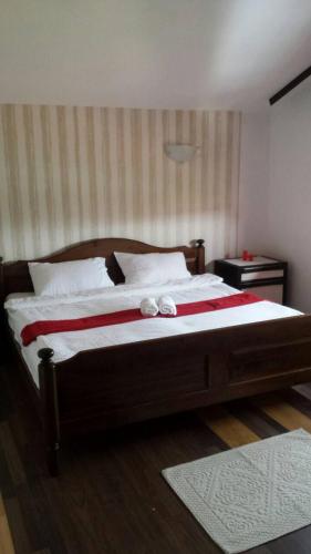 a bedroom with a large bed with two towels on it at Apartman EXCLUZIV in Prijedor