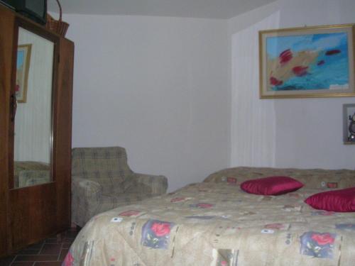a bedroom with a bed with red pillows on it at B&B La Terrazza Del Subasio in Assisi