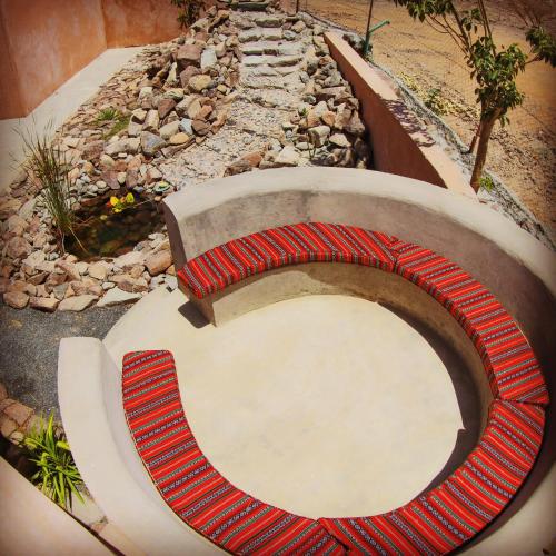a toilet seat in a garden with a fire pit at Alshahad farmhouse in Fujairah