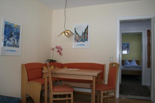 a dining room with a table and chairs and a bed at Haus Sandra in Kitzbühel