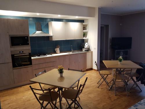 a kitchen and dining room with two tables and chairs at Villa Margherita in Marsala