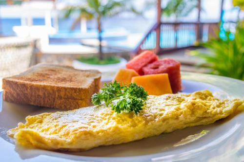 a plate with an omelet and fruit and bread at Lands End in West End