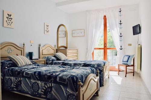 a bedroom with two beds and a window at Campinola Holiday Home PRIVATE POOL in Tramonti