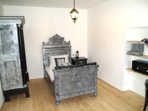 an antique bed in a room with a lamp at Pannonia Terranova in Vardarac