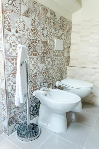 a bathroom with a toilet and a sink at La Maison B&B in Lugo
