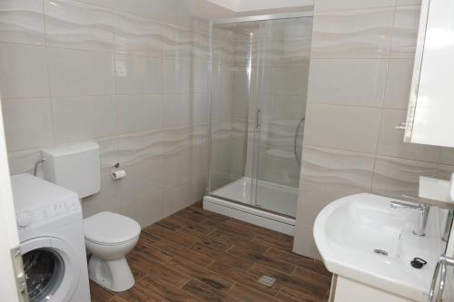 a bathroom with a toilet and a sink and a shower at Apartments Neda in Ploče